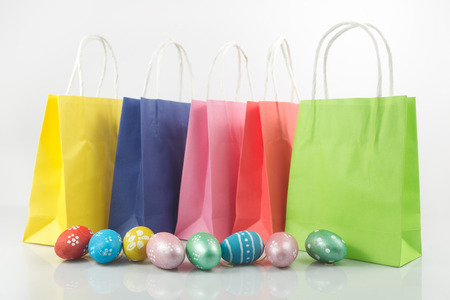 Shopping cart with easter eggs  on white backgroundの写真素材
