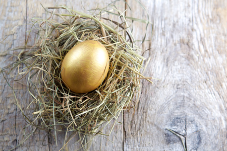 Easter decorations. Eggs in nests on wooden backgroundの写真素材