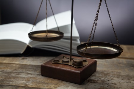 Old vintage balanced scales on black backgroundの写真素材