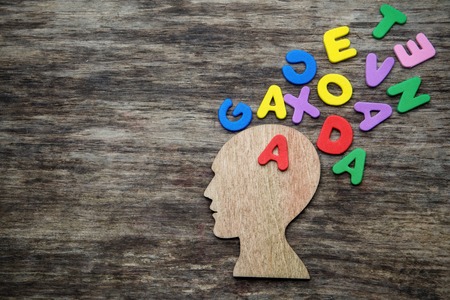 Head silhouette with letters on wooden backgroundの写真素材