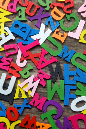 Surface covered with multiple colored wooden letters as a background compositionの写真素材