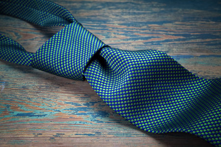 Male necktie on dark textured wooden background