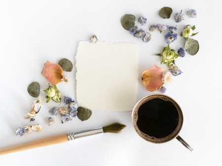 Cup of coffee and dry flovwers at white background. Flat layの写真素材