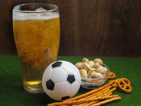 Selection of party food for watching football championship on green grass backgroundの写真素材