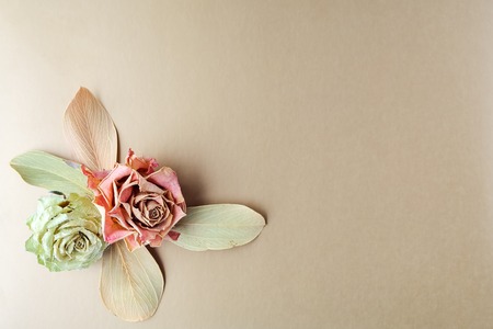 Vintage composition dry bouquet with white roses painted gold and pearl beads. Backdrop useful for wedding cards and other holiday decorationの写真素材