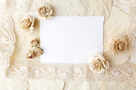 Dried biege flowers andleaves wiht blank paper. Flat lay.の写真素材