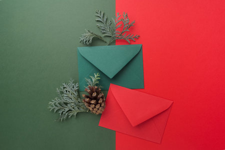 Red and green envelopes on christmas holiday background. Flat lay. Top viewの写真素材