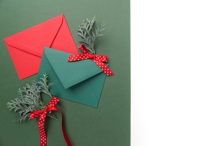 Red and green envelopes on christmas holiday background. Flat lay. Top viewの写真素材