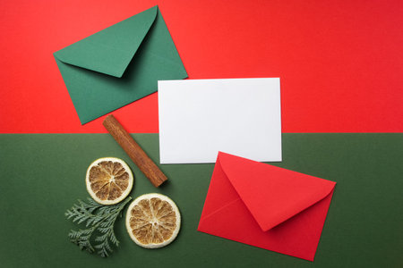 Red and green envelopes on christmas holiday background. Flat lay. Top view