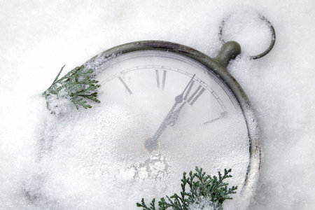 Watch lying in the snow before the new year. Top viewの写真素材