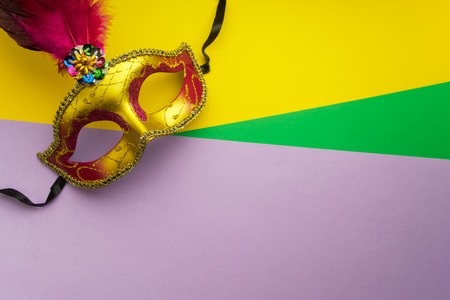 Colorful mardi gras or carnivale mask on a yellow background. Venetian masks. top view.の写真素材