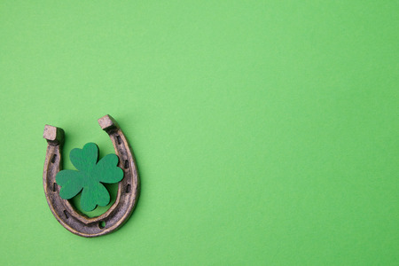 St. Patricks day, lucky charms. Horesechoe and shamrock on green backgroundの写真素材