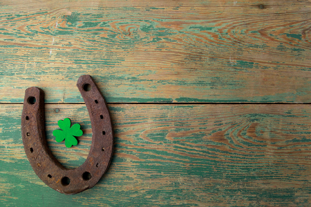 St. Patricks day, lucky charms. Horesechoe and shamrock on wooden backgroundの写真素材