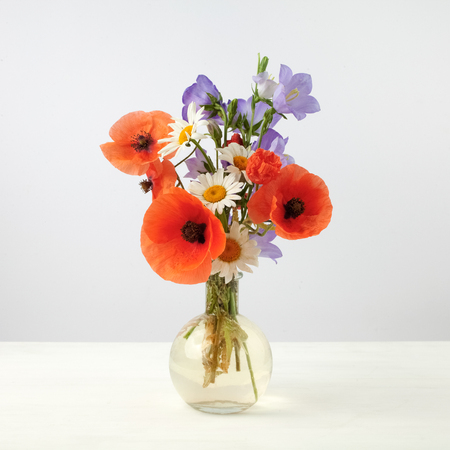 Bouquet of beautiful flowers Chamomiles wheat and poppiesの写真素材