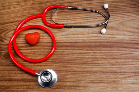 Stethoscope with red heart on a wood backgroundの写真素材