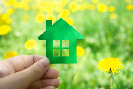 Eco house concept ,hand holding green eco house icon in natureの写真素材