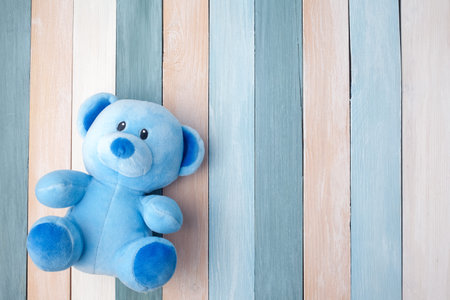 Teddy Bear toy alone on pastel wooden backgroundの写真素材