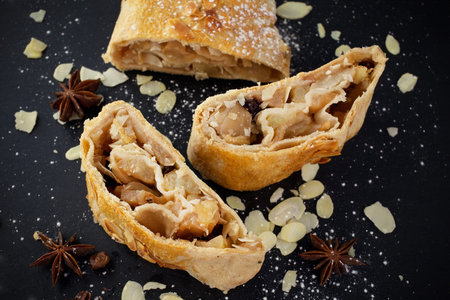 slice of an apple strudel on the black backgroundの写真素材
