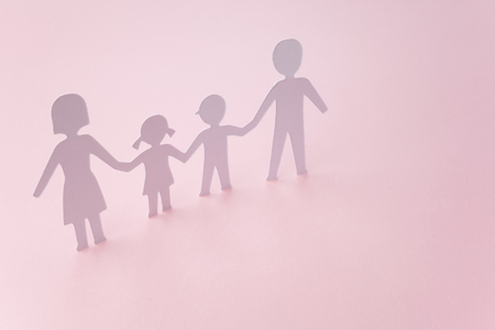 white paper cut family on pink backgroundの写真素材