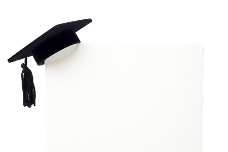 Black Graduation cap on blank white billboardの写真素材