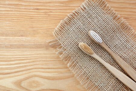 Zero waste concept. Bamboo toothbrush on wooden background. Plastic free essentials, teeth care.の写真素材