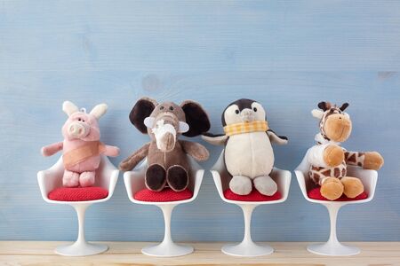 Pediatrician. Toy animals sitting on the chair in hospital. Health center for children. Blue backgroundの写真素材