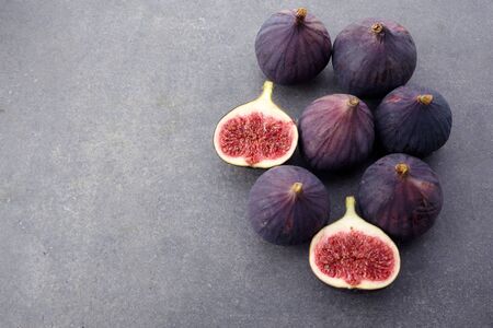 Fresh ripe figs on dark table. Beautiful blue violet figs with empty copyspace close upの写真素材