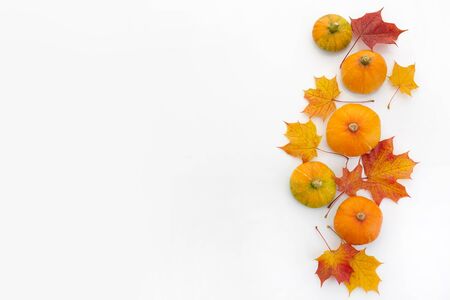Autumn composition. Pumpkins, dried leaves on white background. Autumn, halloween concept. Flat lay, top viewの写真素材