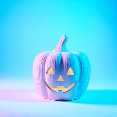 A Jack O Lantern glowing with neon light on Halloween evening.の写真素材