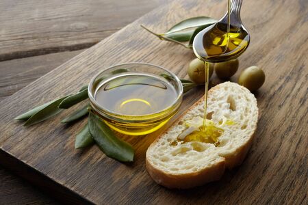 slice of bread seasoned with olive oil on wooden tableの写真素材