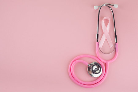 Pink ribbon and stethoscope on pink background, Symbol of breast cancer in women, Health care conceptの写真素材