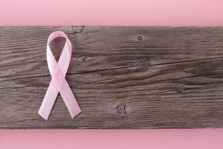 pink ribbon breast cancer on wooden background. Top viewの写真素材