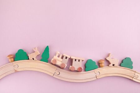Zero waste. Eco wooden toys on pink background. Flat lay. Top viewの写真素材