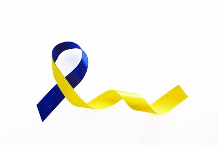 Blue and yellow ribbon on white background. World down syndrome day. Awareness ribbon.の写真素材