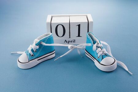 April fools day. Surprise symbol. Shoelaces tied together on blue wooden background. April fool.の写真素材