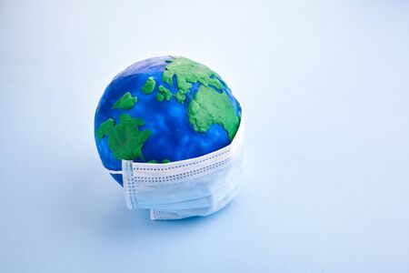 Mask on Globe, pandemic background for medical design. Stop pandemic concept. Health bacteria virus protection.の写真素材