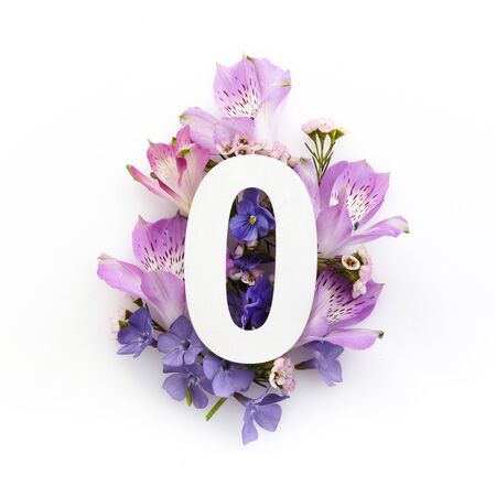 Creative layout with colourful flowers and number zero. Flat lay. Top view.の写真素材
