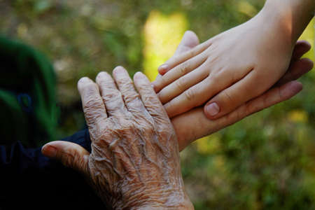 Old women and young boy holding hands. Family love concept.の写真素材