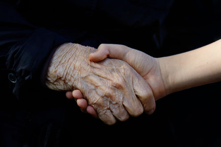 Old and young holding hands. Family love concept. Healthcare background.