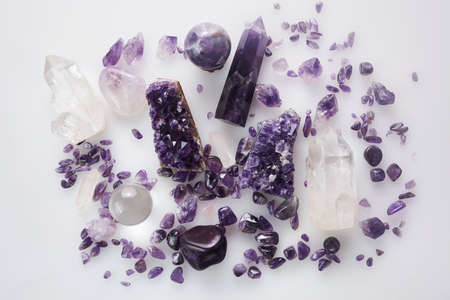 Healing purple amethyst stones on white background. Crystals for ritualの写真素材