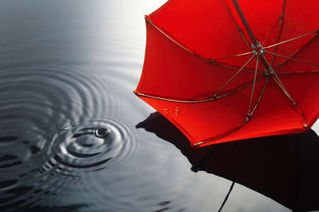 Umbrella on the rain. Umbrella inpuddle. Autumn background concept.の写真素材