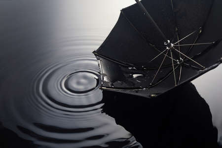 Umbrella on the rain. Umbrella inpuddle. Autumn background concept.の写真素材