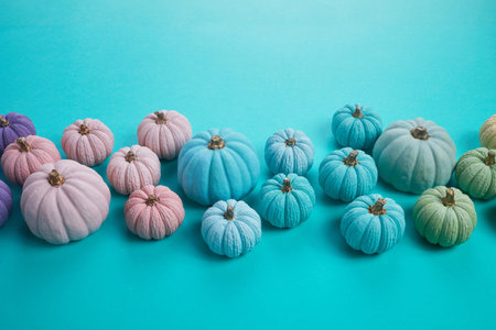 Rainbow pumkins on aqua colour background. Harvest thanksgiving halloweenの写真素材