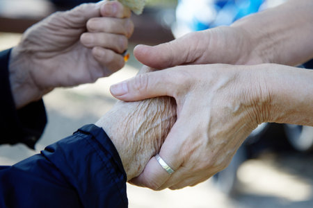 Helping hands. Care for the eldery concept. Two womans hands.
