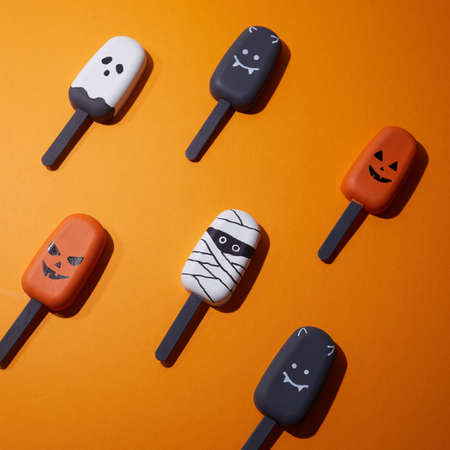 Set of ice cream with halloween character face on orange background. Halloween party backgroundの写真素材
