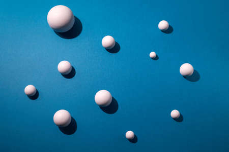 White balls on blue background. Flat lay, top viewの写真素材