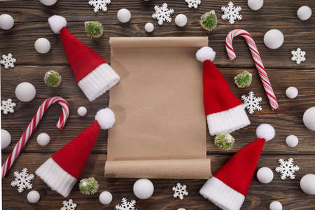 Empty wishlist for Santa Claus on wooden table with Christmas decorations. Top view.の写真素材