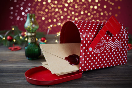 Santa Claus Christmas post on wooden background with Christmas tree decorations.