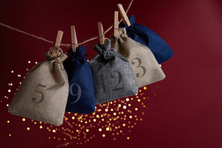 Advent calendar with surprise for Christmas on red background