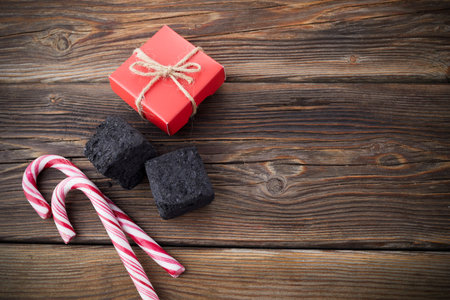Christmas coal for bad kids ant candys or gift for good children. Christmas tradition in many countries.の写真素材